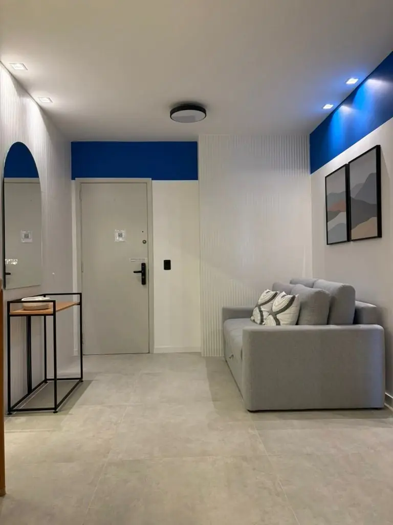 Sala de apartamento moderno e iluminado com varanda voltada para o mar
